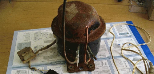 Fridge compressor with its start relay attached, before cleaning
